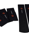 Folded and unfolded Black riding socks with white Jackie&Co text and orange line art horse head logo.