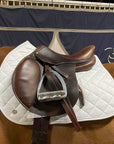A chestnut horse wearing a Jackie&Co friction shield saddle pad under a brown leather saddle.