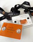 Jackie&Co black lanyards with white lucky number pins.