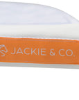 A close of view of the Jackie&Co orange tag on the top seam of a friction shield saddle pad.