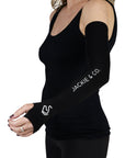 Black UV protective riding sleeves featuring thumb holes, with 'Jackie&Co' written in white along the forearm and a line art horse logo on the top of the hand being worn.