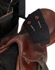 Black Jackie&Co riding socks on a brown leather saddle.