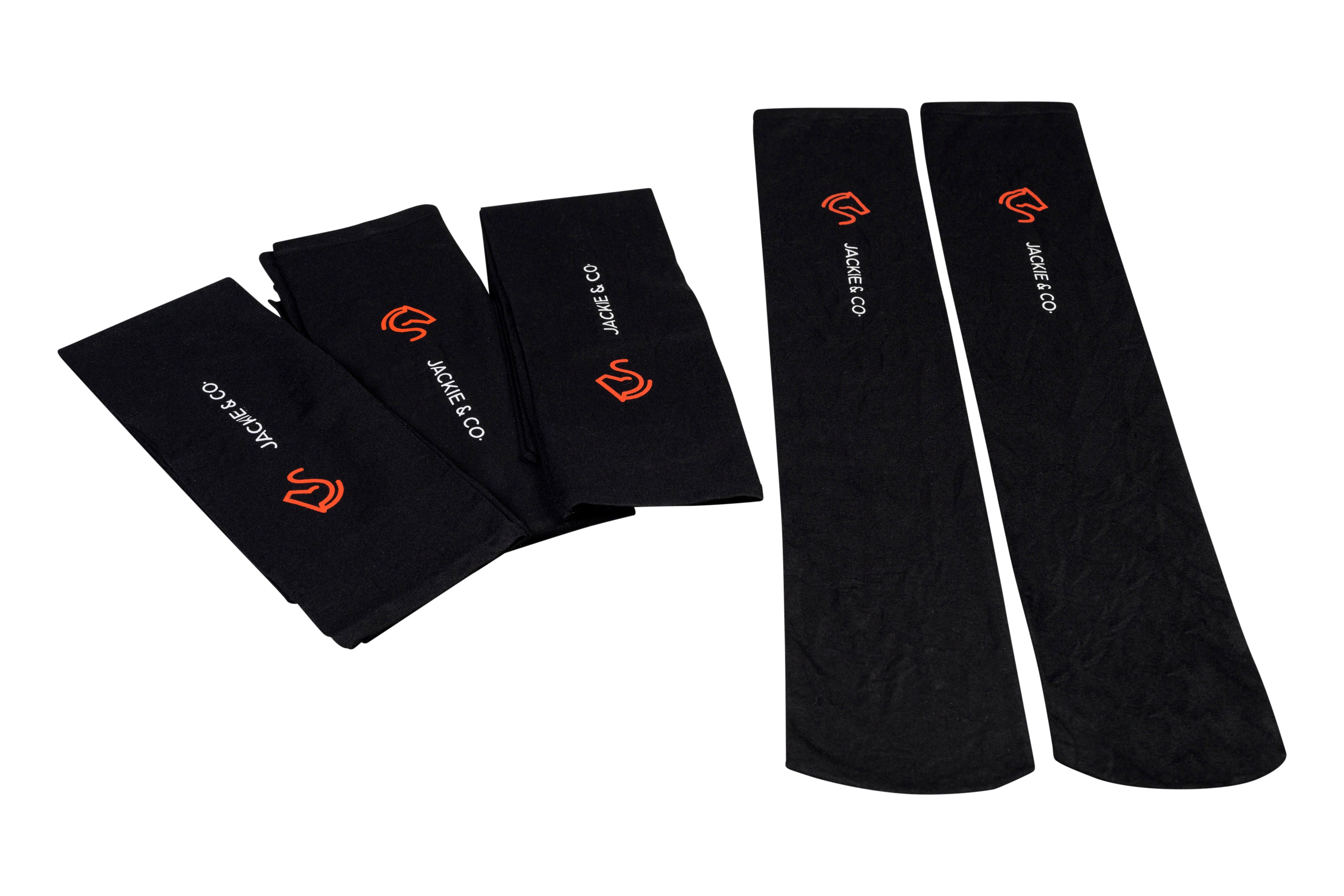 Folded and unfolded Black riding socks with white Jackie&Co text and orange line art horse head logo. 