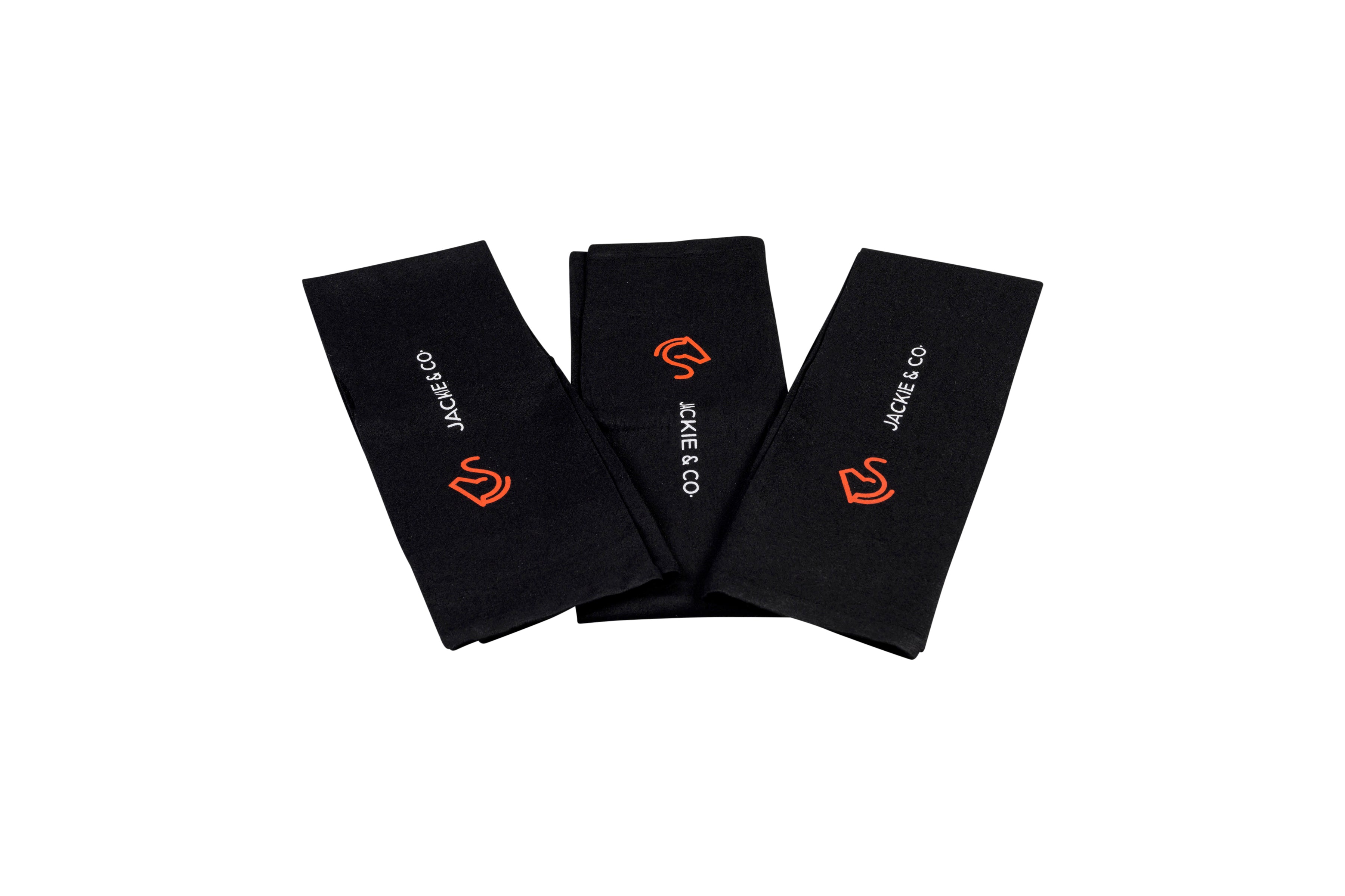 Folded Black riding socks with white Jackie&Co text and orange line art horse head logo.