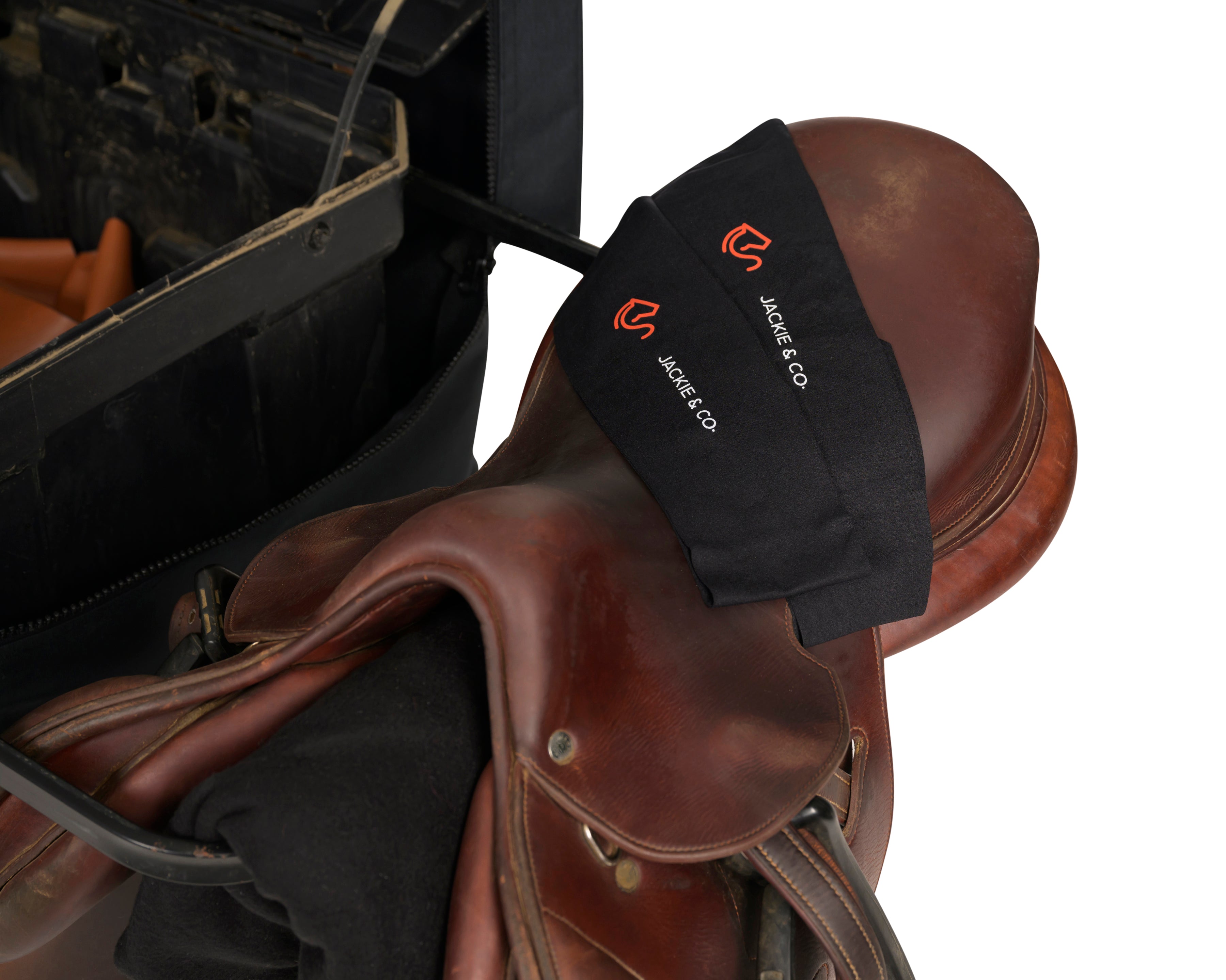 Black Jackie&Co riding socks on a brown leather saddle. 